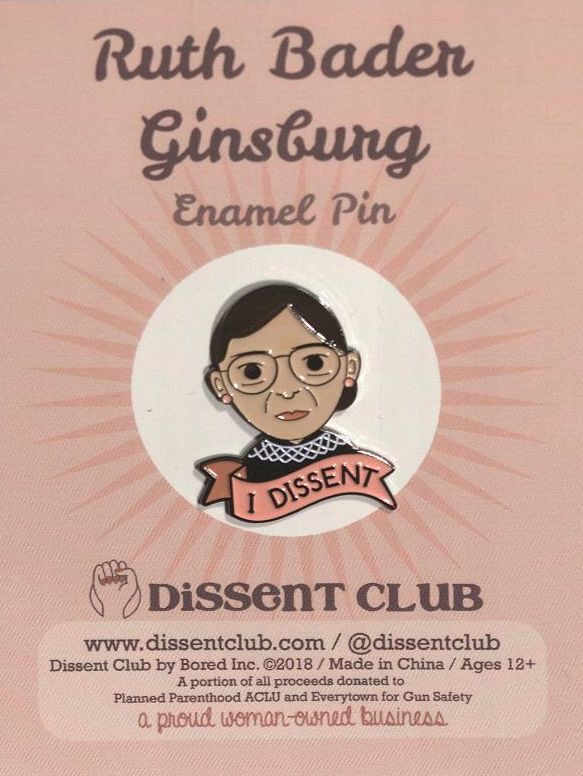 A enamel lapel pin of Ruth Bader Ginsberg that says "I dissent"