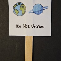 Keep the Earth Clean. It's Not Uranus. Mini Protest Sign with an image of the Earth and Uranus.
